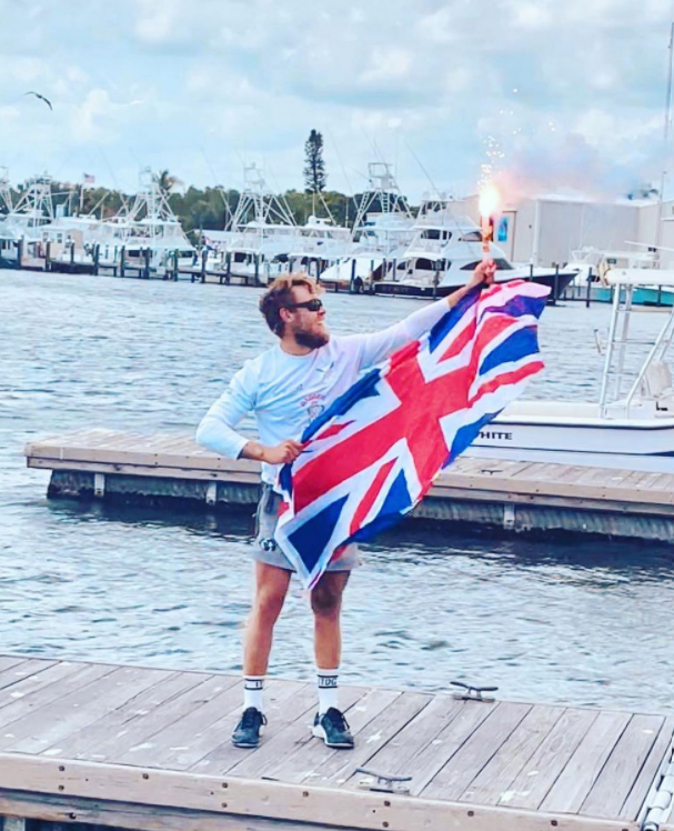 Jack celebrating his landing with GB flag and flare