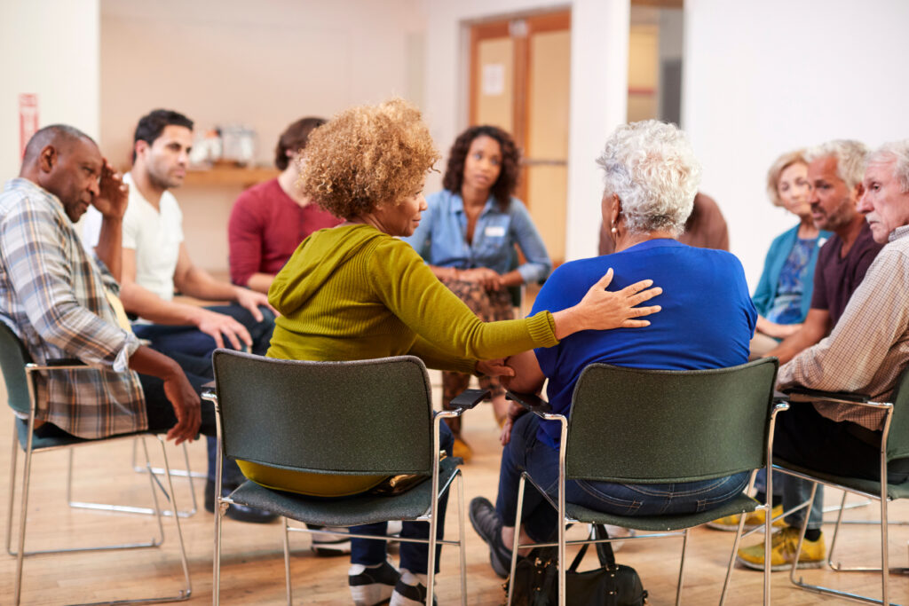 A group of caregivers supporting eachother in a circle