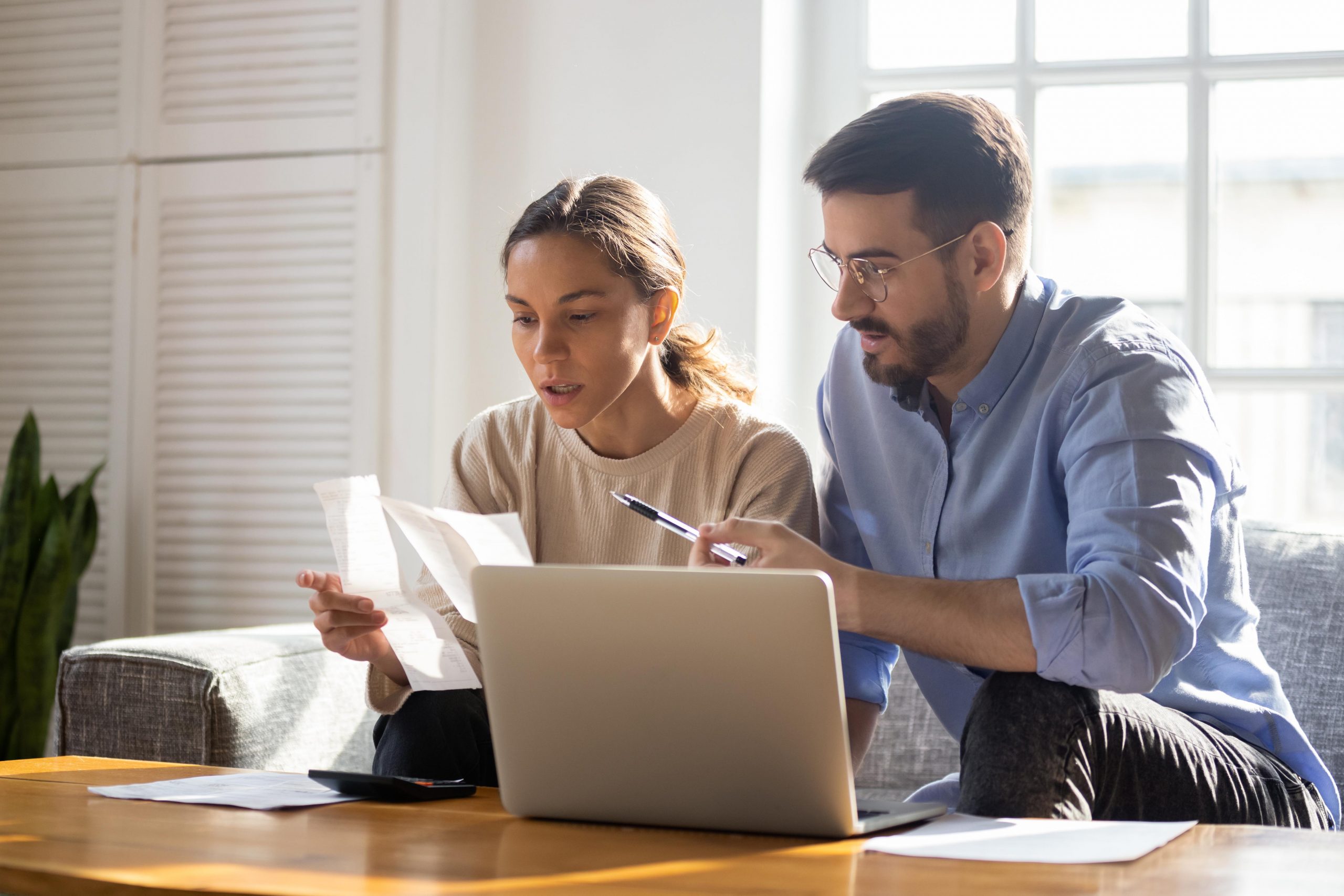 Stock photo of two people looking at finances. 