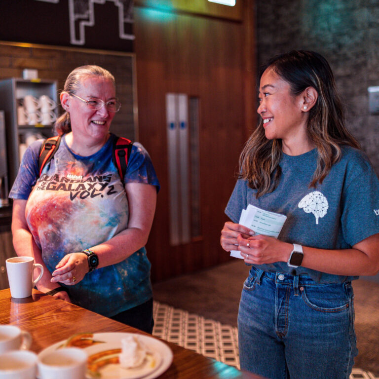 Patient and carer sharing a coffee over conversation