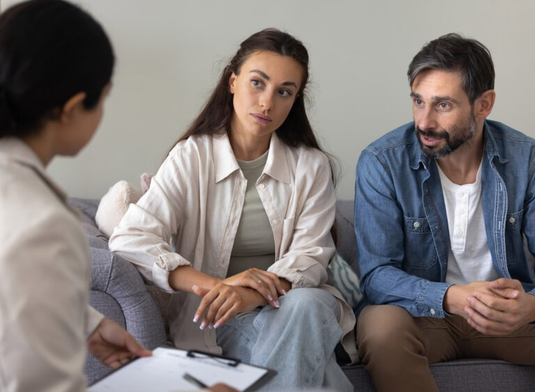 Couple listening to doctor giving out information