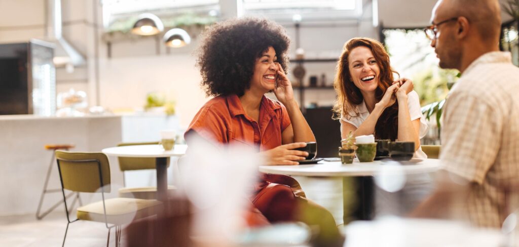 People smiling, talking and laughing - living well with a brain tumour